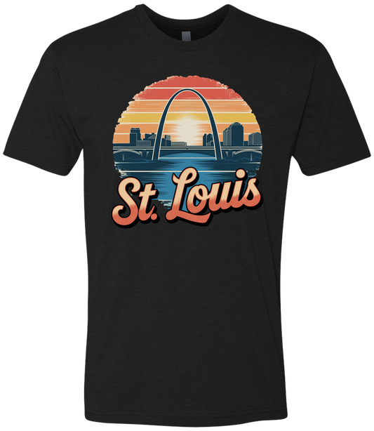 A black t-shirt featuring a graphic print of the St. Louis Gateway Arch with a sunset in the background and the text 'St.