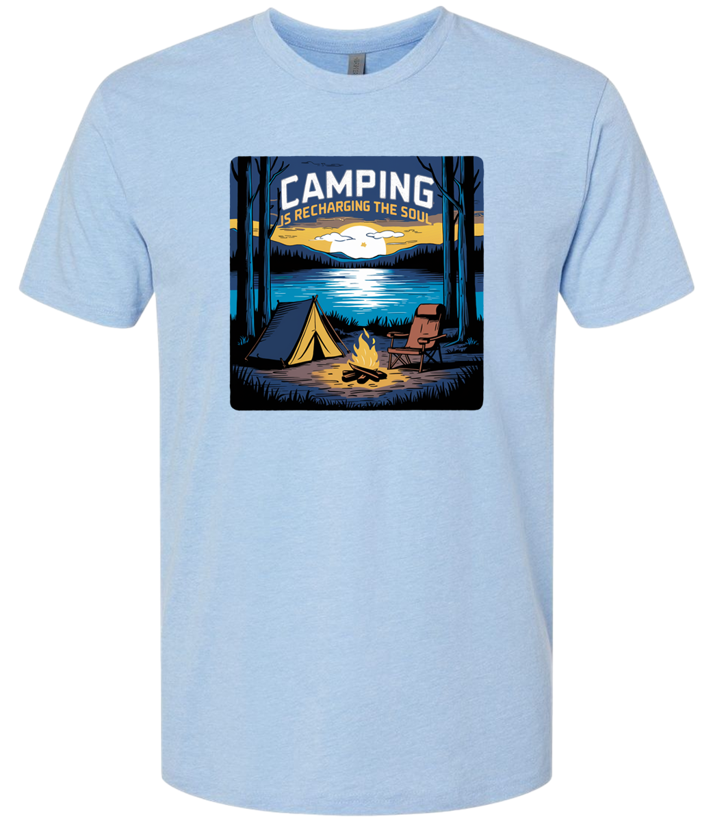 A light blue crewneck t-shirt with a graphic print of a camping scene, including a tent, trees, and a campfire.