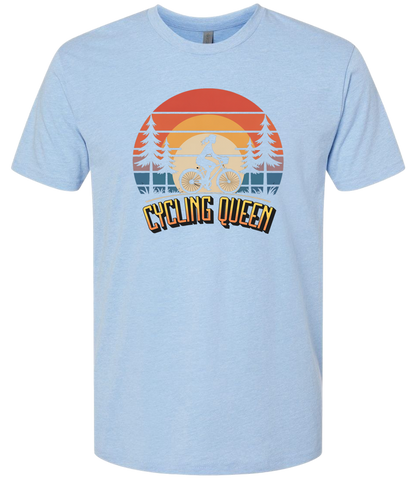 Light blue t-shirt with 'Cycling Queen' graphic design with a retro sunset behind de graphic