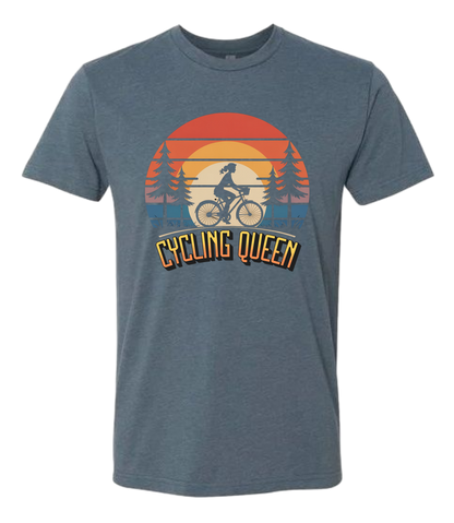 Light blue t-shirt with 'Cycling Queen' graphic design with a retro sunset behind de graphic