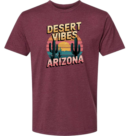 A maroon-colored crewneck t-shirt with the text 'DESERT VIBES ARIZONA' printed on the front.