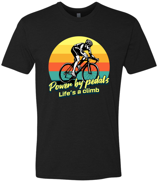 Man riding road bicycle with sunset behind and the words power by pedals, life's a climb front and center