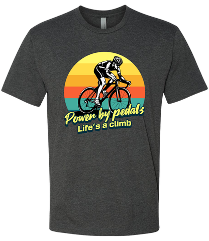Man riding road bicycle with sunset behind and the words power by pedals, life's a climb front and center