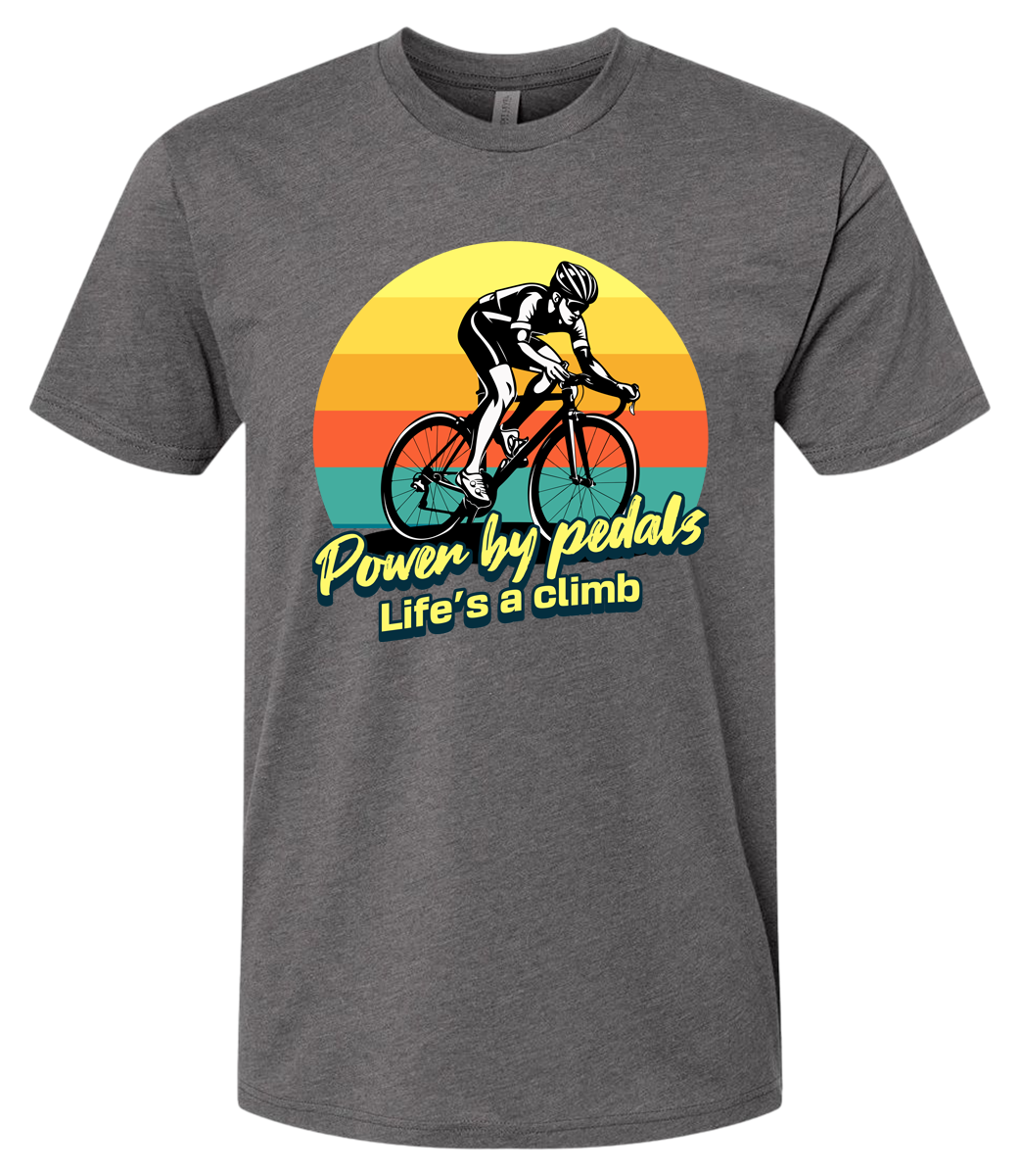 Man riding road bicycle with sunset behind and the words power by pedals, life's a climb front and center