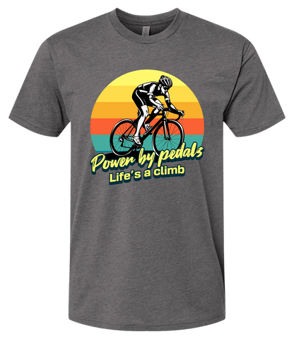 Man riding road bicycle with sunset behind and the words power by pedals, life's a climb front and center