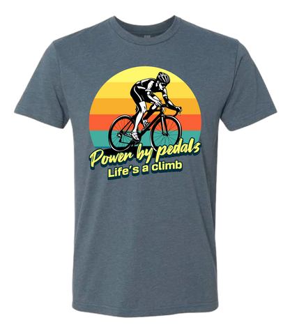 Man riding road bicycle with sunset behind and the words power by pedals, life's a climb front and center