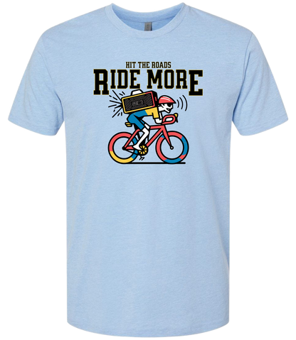 Light blue t-shirt with a graphic of a person on a bike and text 'Hit the roads, ride more' on a white background.