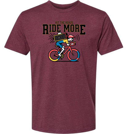 Maroon t-shirt with a graphic of a cyclist and text 'Hit the roads, Ride More' on a white background.