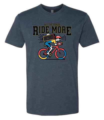 Blue t-shirt with a graphic of a person on a bicycle and text 'Hit the roads, Ride More' on a white background.