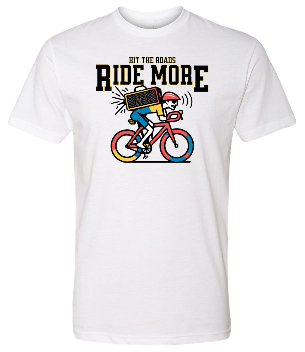 White t-shirt with a graphic of a person riding a bicycle and text 'Hit the roads, Ride More' on a white background.